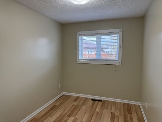 Empty room with wooden floor and window.