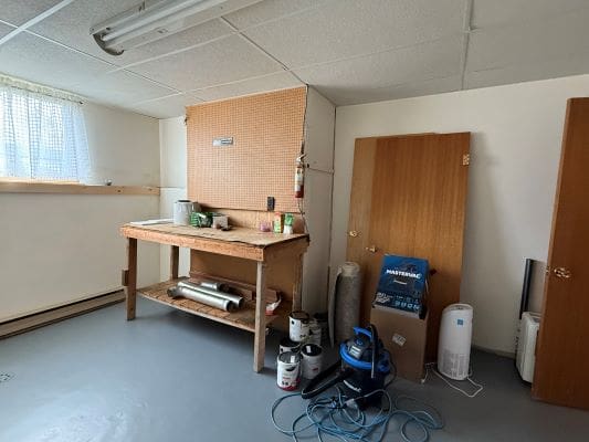 Basement workshop with tools and equipment.