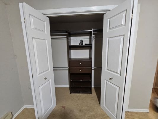 White closet with open doors.