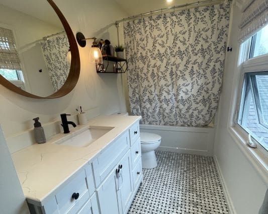 Modern bathroom with patterned shower curtain.