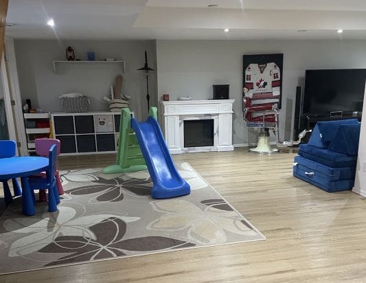 Children's playroom with slide and toys.