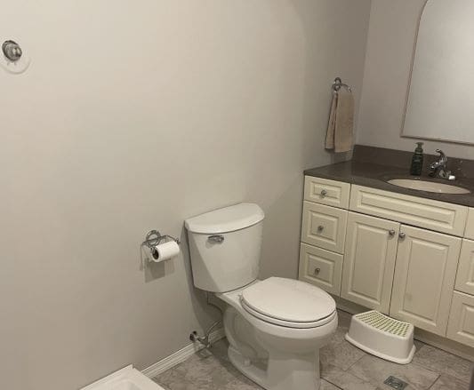 Bathroom with toilet and sink area.