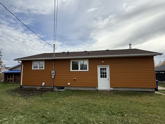 Orange house with white door and windows.