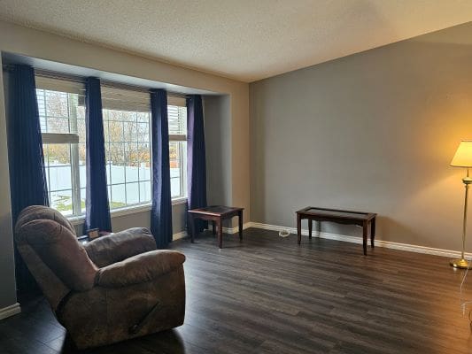 Spacious living room with minimal furniture.