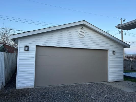 White garage with closed beige door.