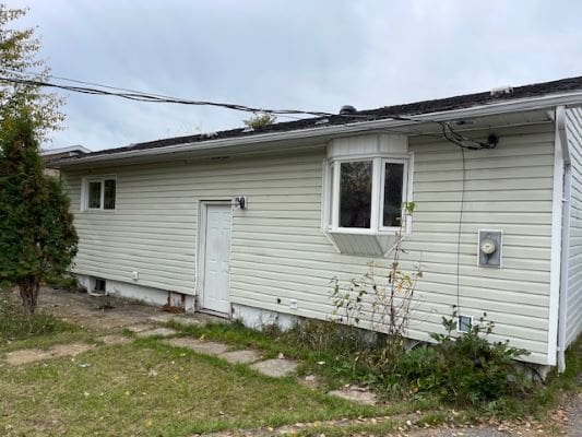 Single-story house with white siding.