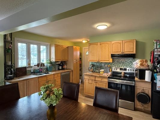 Cozy kitchen with wooden cabinets and table.