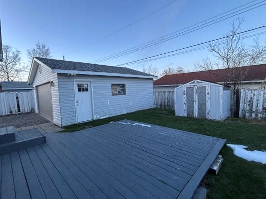 Backyard with a garage and shed.