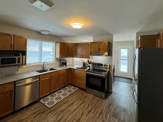 Modern kitchen with wooden cabinets and appliances.