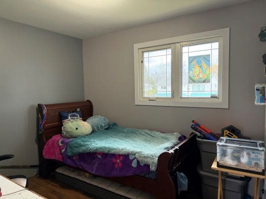 Child's bedroom with bed and window.
