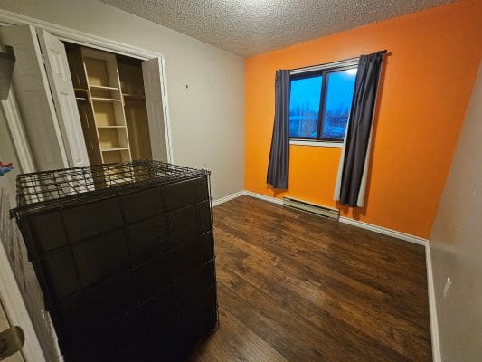 Empty room with orange accent wall.