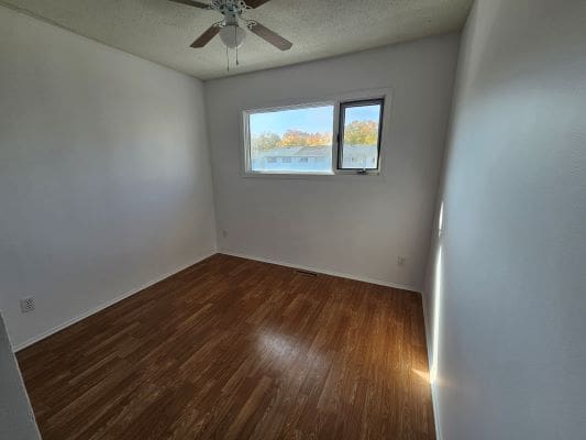 Empty room with wooden floor and window.