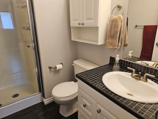 Small bathroom with shower and sink.