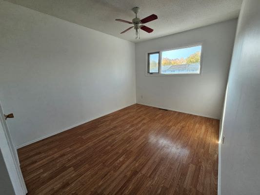 Empty room with wooden floor and window.