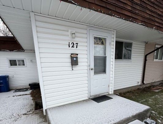 House entrance with snow-covered steps.