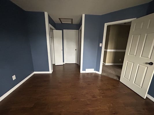 Empty room with blue walls and doors.