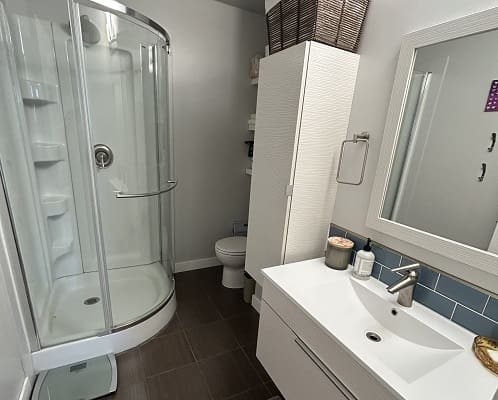 Modern bathroom with shower and vanity.
