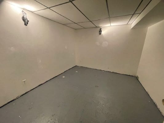 Empty room with plain walls and lights.