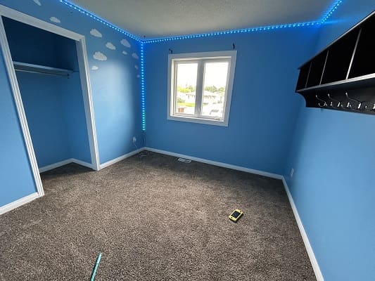 Blue room with clouds and window.