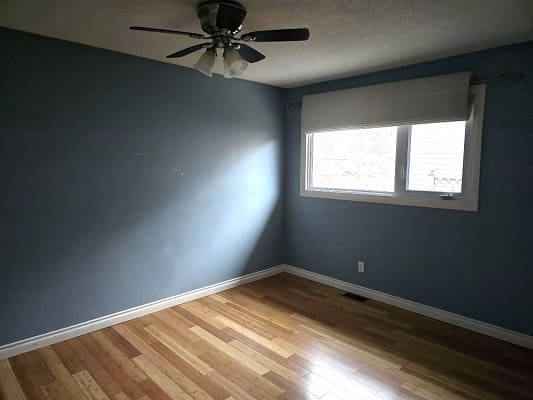 Empty room with wooden floor and window.