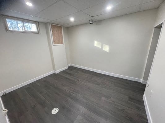 Empty room with dark wood flooring.