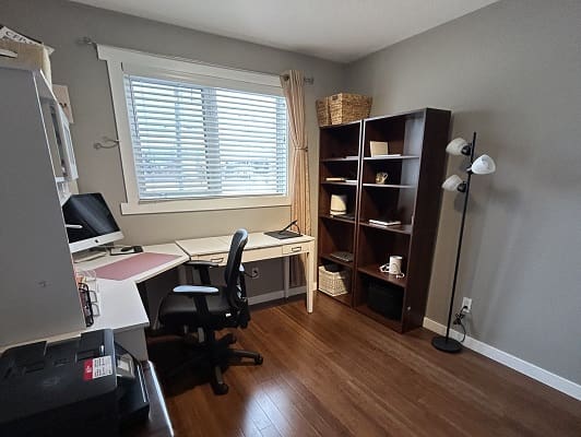 Home office with desk and bookshelves.