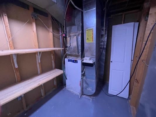 Basement utility room with shelves and furnace.