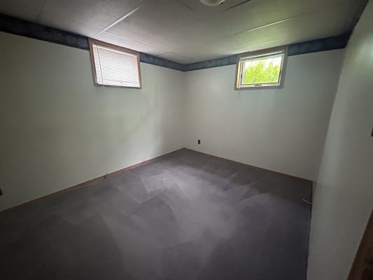 Empty room with two small windows.