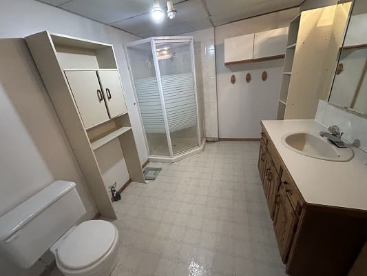 Spacious bathroom with shower and vanity.