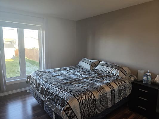Bedroom with large bed and window view.