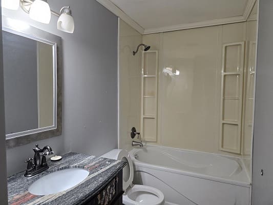 Modern bathroom with tub and sink.
