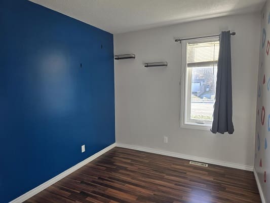 Empty room with blue accent wall.