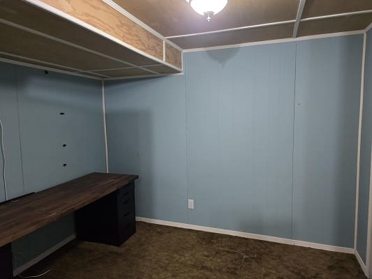 Empty room with desk and blue walls.