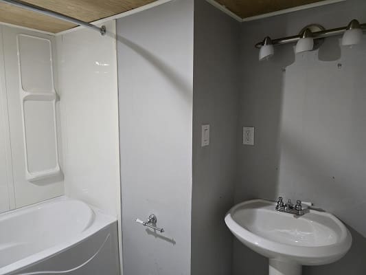 Modern bathroom with sink and bathtub.