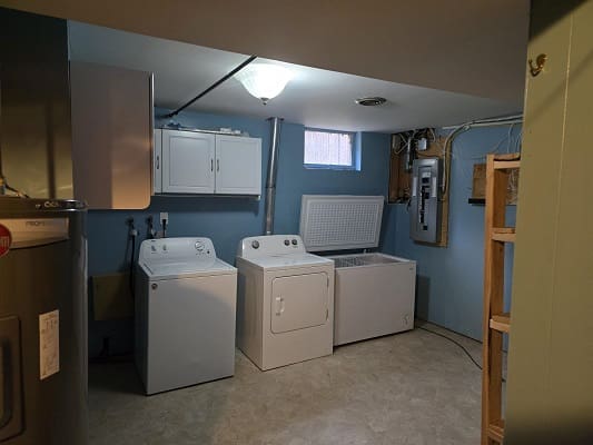 Basement laundry room with washer and dryer.