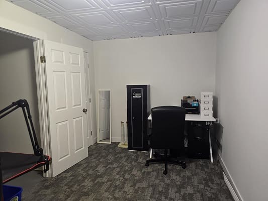 Small office with desk and chair.
