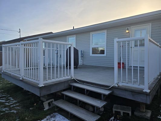 House deck with white railing and steps.