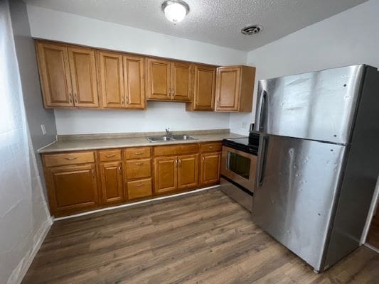 Wooden kitchen cabinets with stainless steel appliances.