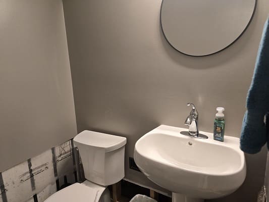 Bathroom with sink, toilet, and mirror.