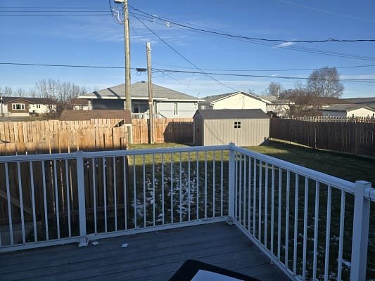 Backyard with deck and storage shed.