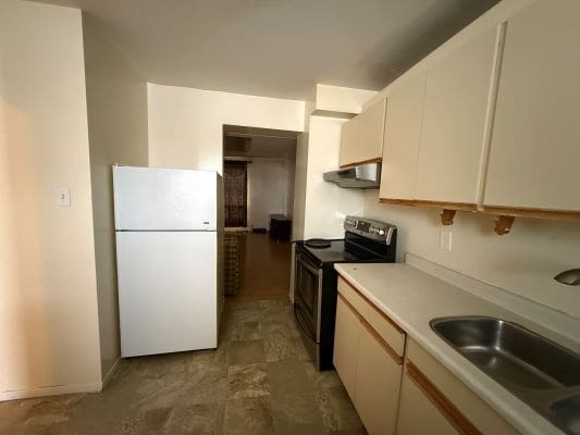 Small kitchen with fridge and stove.