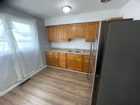 Wooden kitchen cabinets with stainless steel appliances.