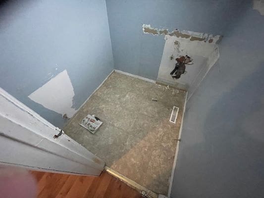 Empty room with exposed drywall and floor.