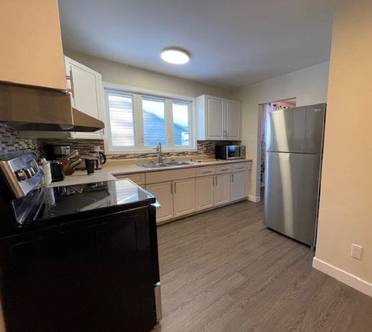 Modern kitchen with stainless steel appliances.