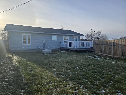 House with deck and fenced backyard.