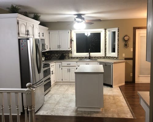 Modern kitchen with white cabinets and island.