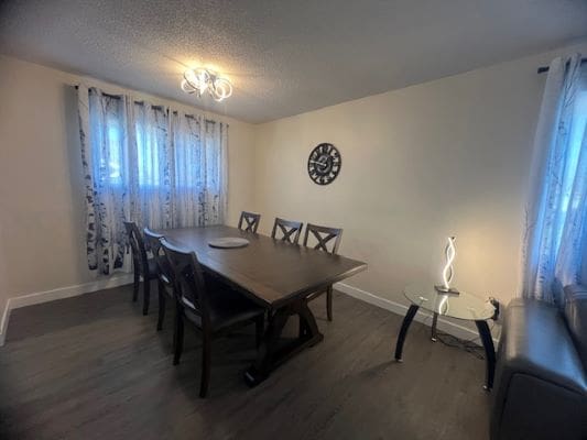 Dining room with table and decorative clock.