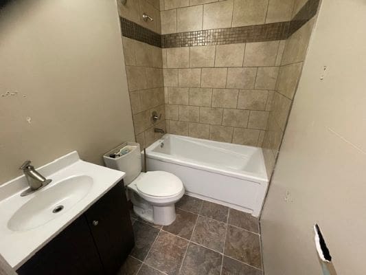Small bathroom with bathtub and sink.