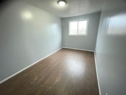 Empty room with wooden floor and window.