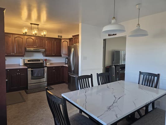 Kitchen and dining area with marble table.